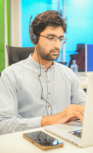 InvoZone team member working on a laptop